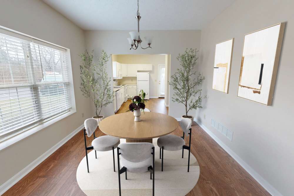 Dining area with round table and chairs at Whispering Wind Apartments & Townhomes in Newtown, Ohio