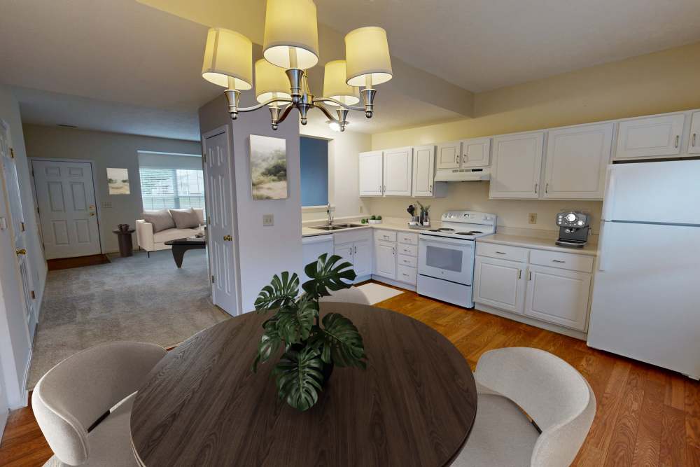 Kitchen with white appliances at Whispering Wind Apartments & Townhomes in Newtown, Ohio