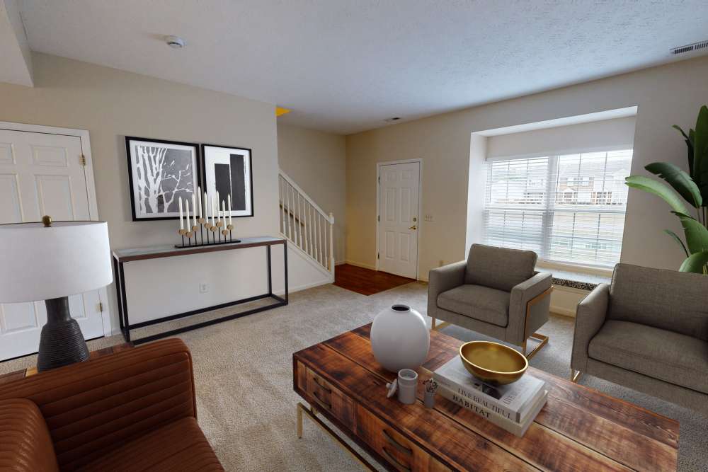 Cozy living room with modern furniture and natural light at Whispering Wind Apartments & Townhomes in Newtown, Ohio