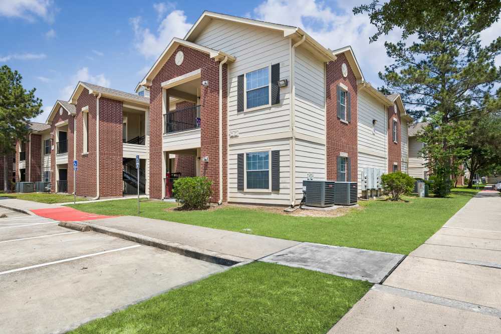 Community exterior view sidewalk  at Montgomery Pines Apartments in Porter, Texas