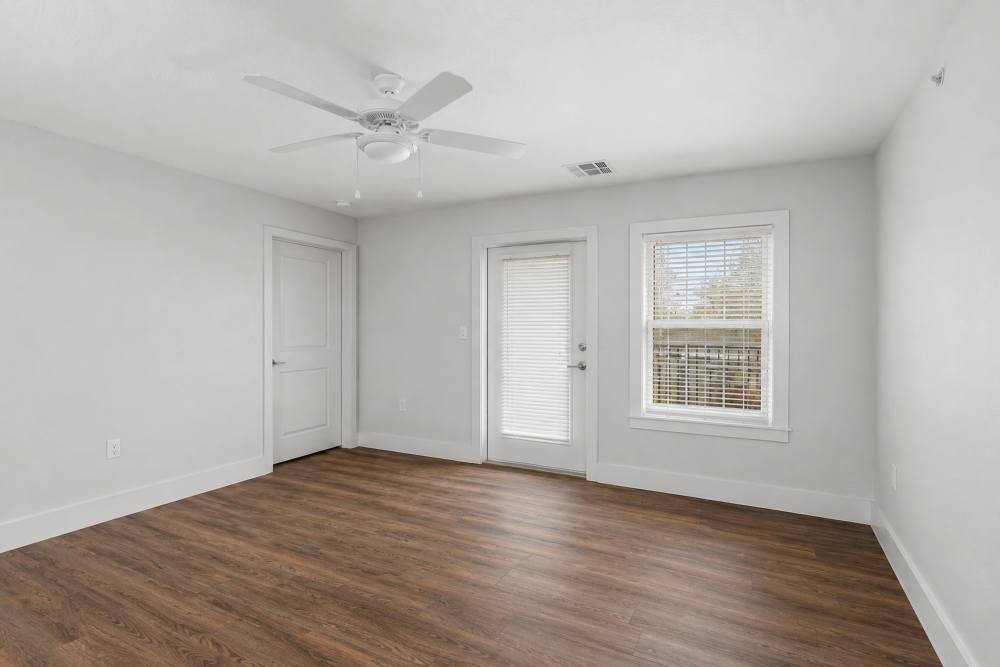 Living room with ceiling fan and a window at Covington Woods II in Lansing, Kansas 