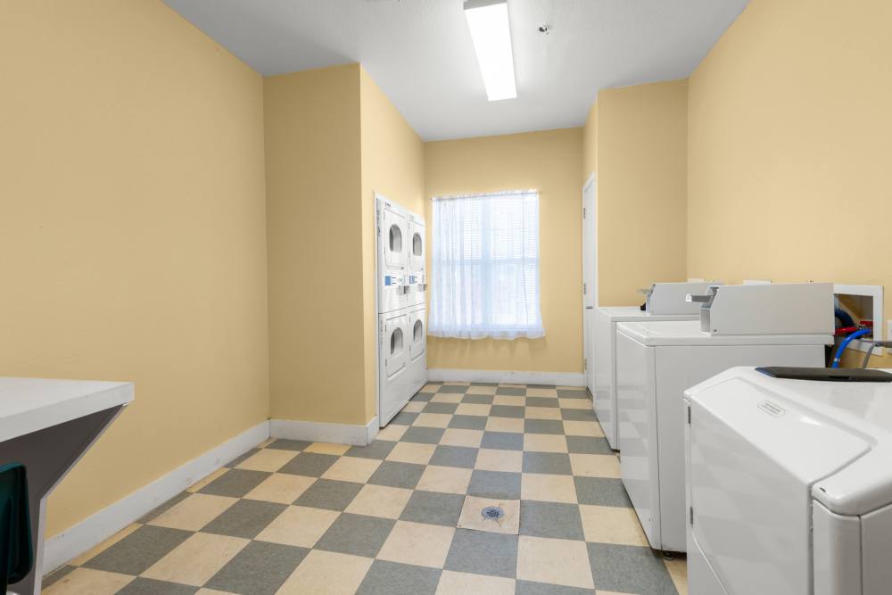 Washer and dryer in community laundry room at The Arbors at Rose Park in Abilene, Texas