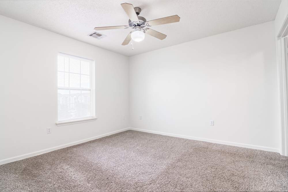 Spacious bedroom with ceiling fan at Gateway Plaza Apartments in Midland, Texas
