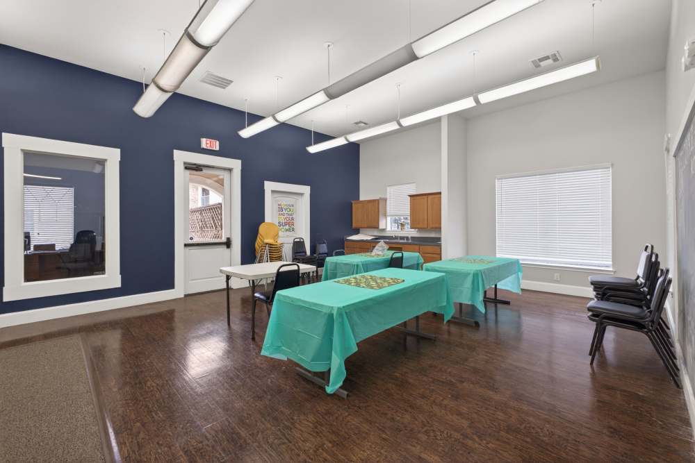 Community room with tables at Rosemont At Lakewest in Dallas, Texas