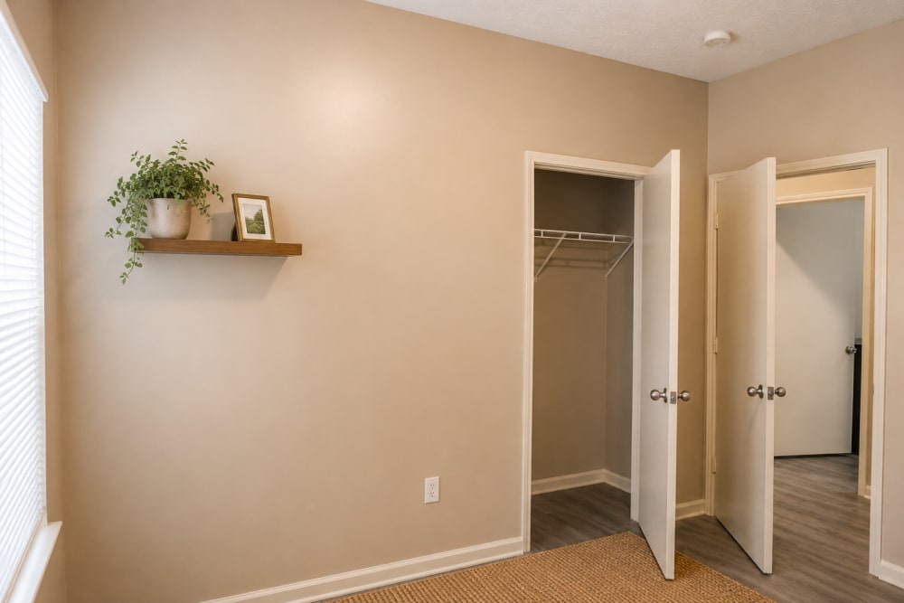 Bedroom with a walk-in closet and a window at Riverchase Park Apartments in Gulfport, Mississippi 