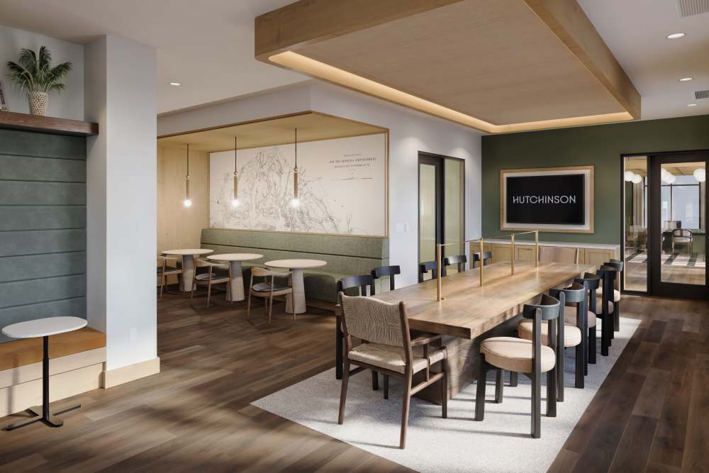 Community lounge with large dining table at Hutchinson in Summerville, South Carolina