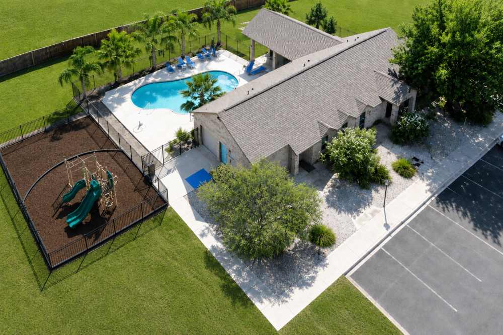 Pool and playground area at Tuscany Court Townhomes in Hondo, Texas