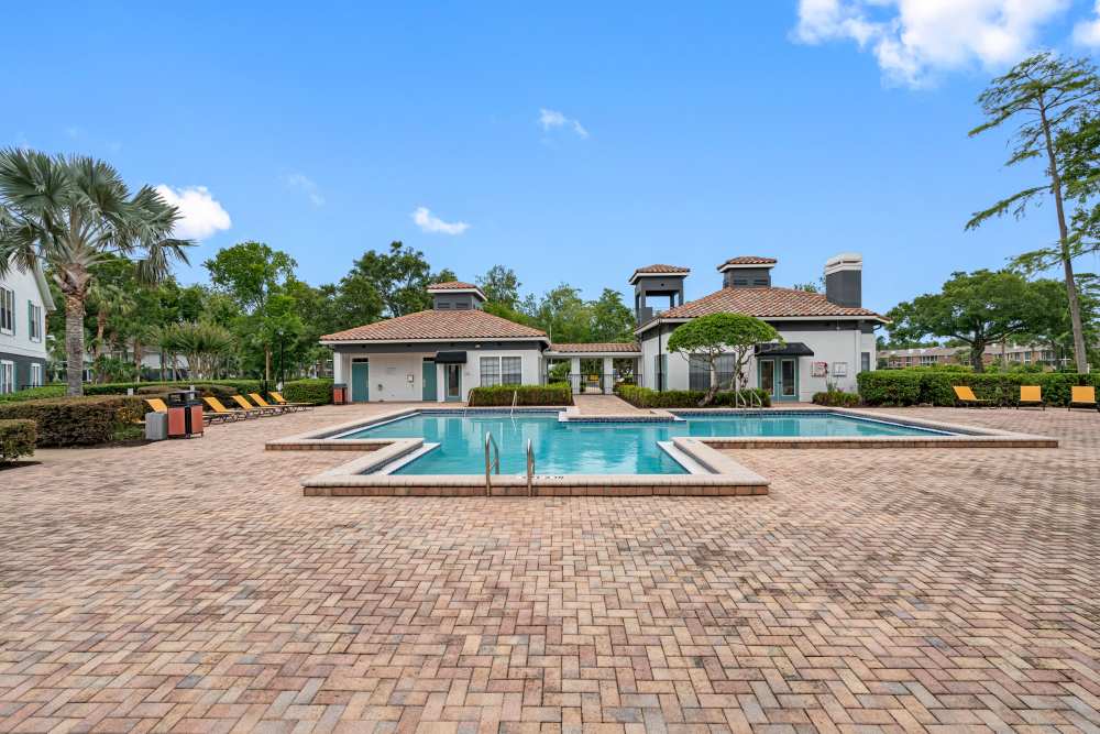 Resort-style pool with seating area at Lake Forest in Daytona Beach, Florida