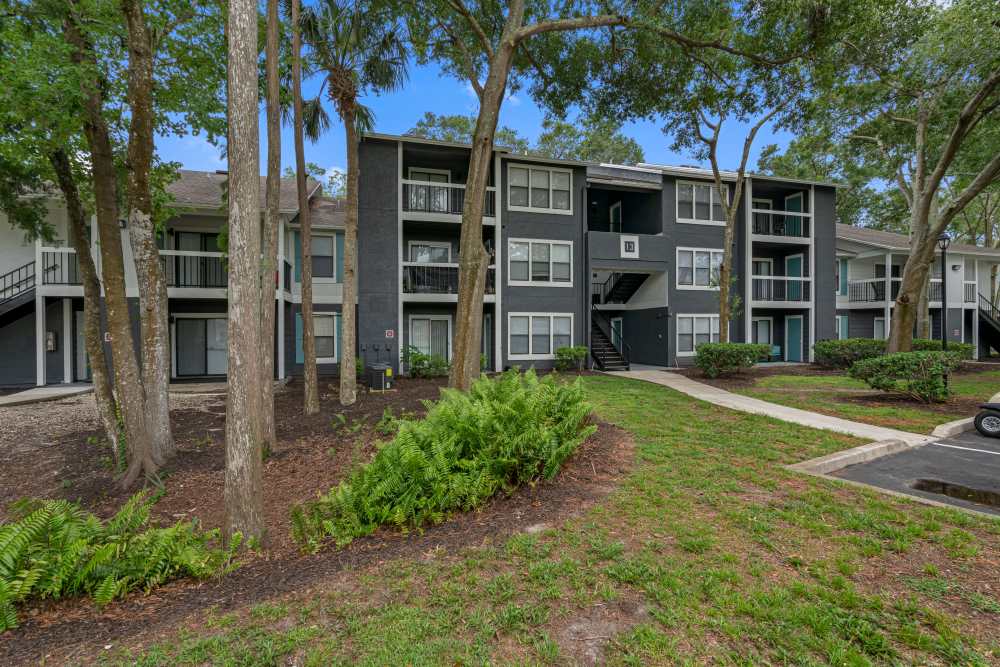 Lush landscaping with modern apartment exteriors at Lake Forest in Daytona Beach, Florida