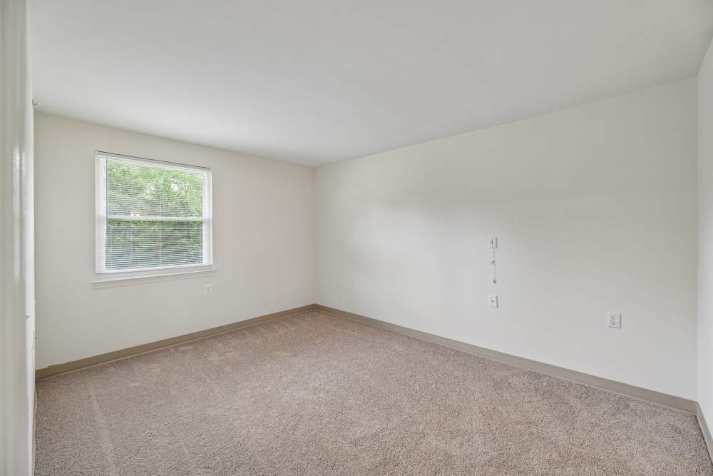 Bedroom with a window at Randolph Village Senior Apartments in Silver Spring, Maryland 