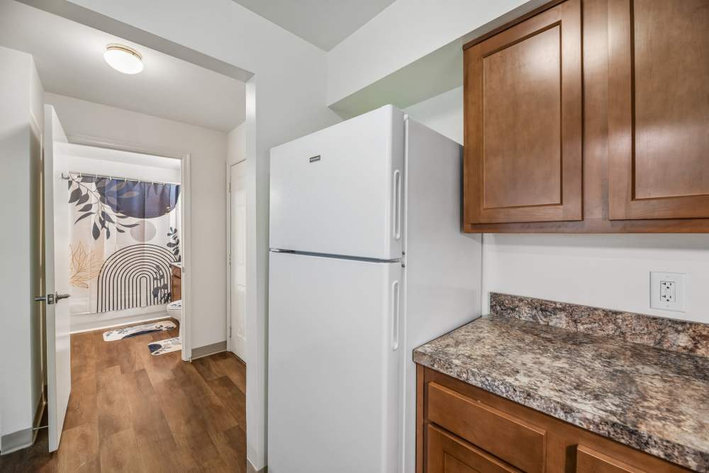 Kitchen with a refrigerator at Randolph Village Senior Apartments in Silver Spring, Maryland 