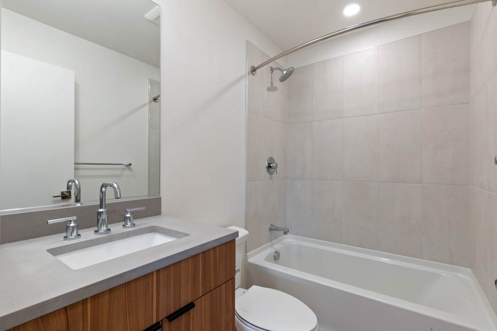 Modern bathroom with tub and sleek vanity at 707 Leahy in Redwood City, California