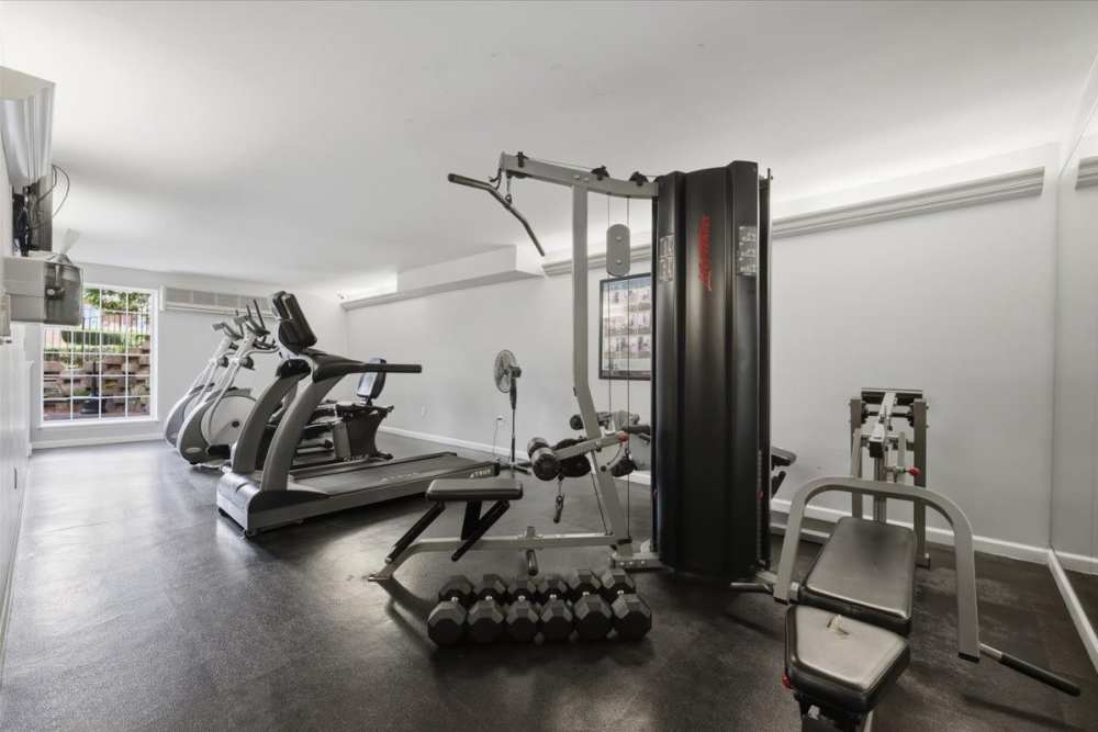 Well-equipped fitness center with various exercise equipment at Beau Jardin Apartments in St. Louis, Missouri