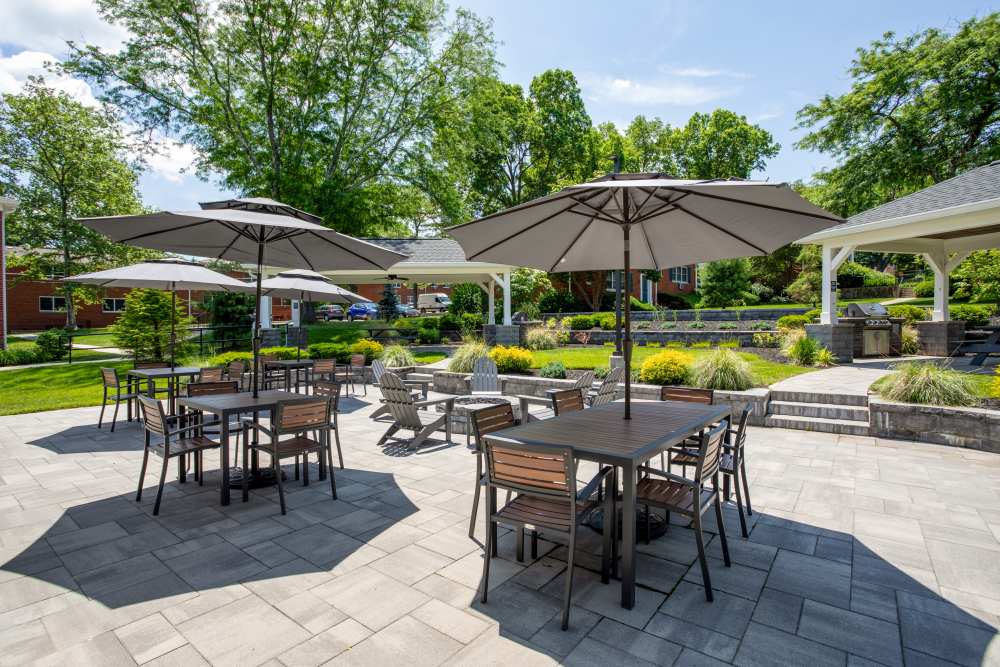 Courtyard patio with tables, umbrellas, and fire pit seating area at Center Grove Village in Randolph, New Jersey