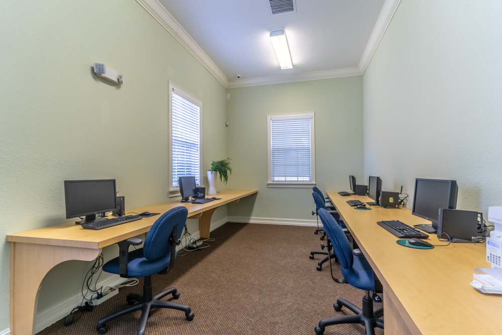Computer workstations with blue chairs at Newport Sound Apartments in New Smyrna Beach, Florida
