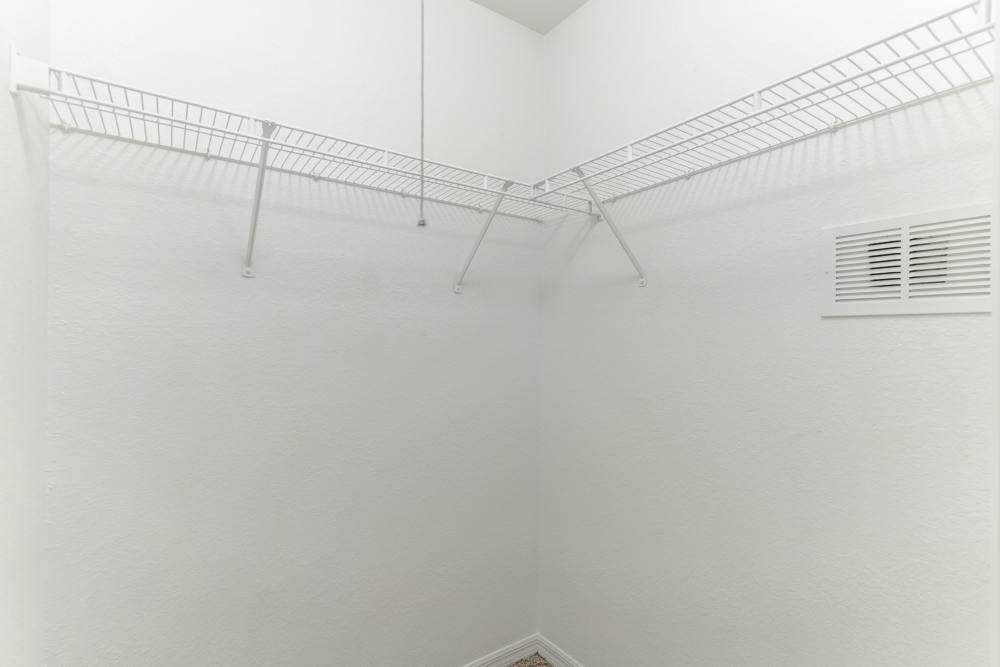 Spacious walk-in closet with wire shelving at Newport Sound Apartments in New Smyrna Beach, Florida