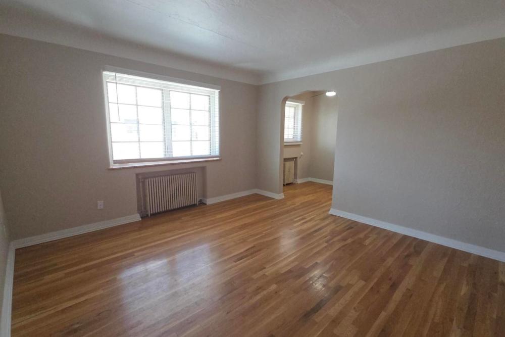 Spacious living area with wood floors and window at Cascade Park in Colorado Springs, Colorado