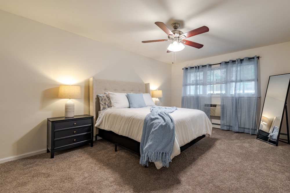 Carpeted bedroom with full size bed and matching nightstands at Park Apartments in Bordentown, New Jersey
