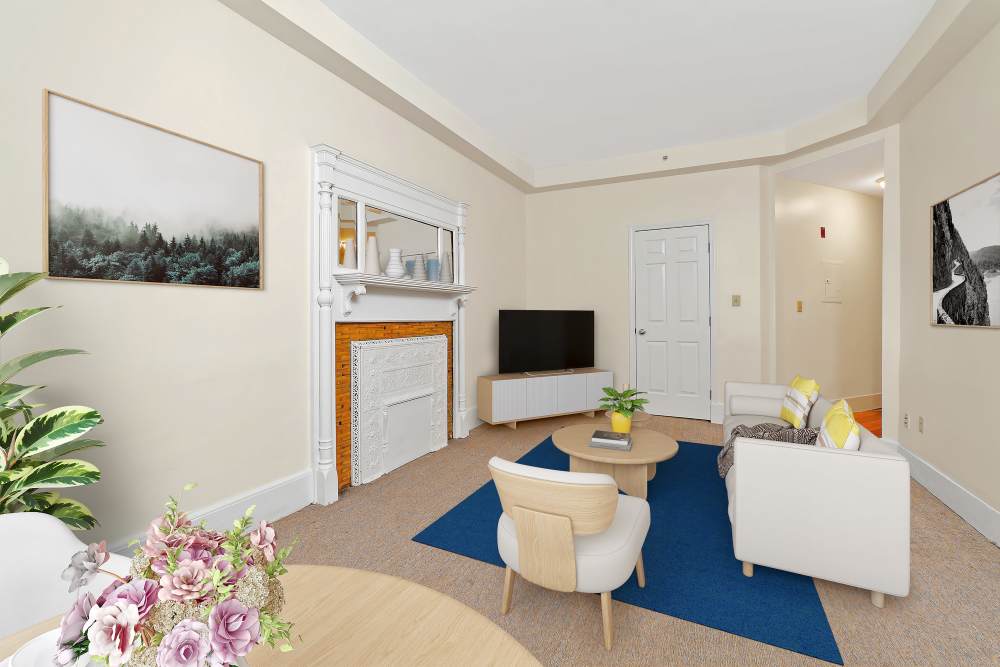 Cozy living room with fireplace, sofa, coffee table, and TV at 71 Westland Apartments in Boston, Massachusetts