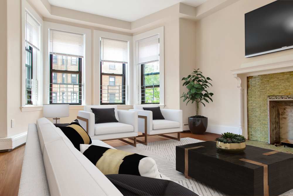Modern living room with sectional sofa, armchairs, coffee table, and fireplace at 71 Westland Apartments in Boston, Massachusetts