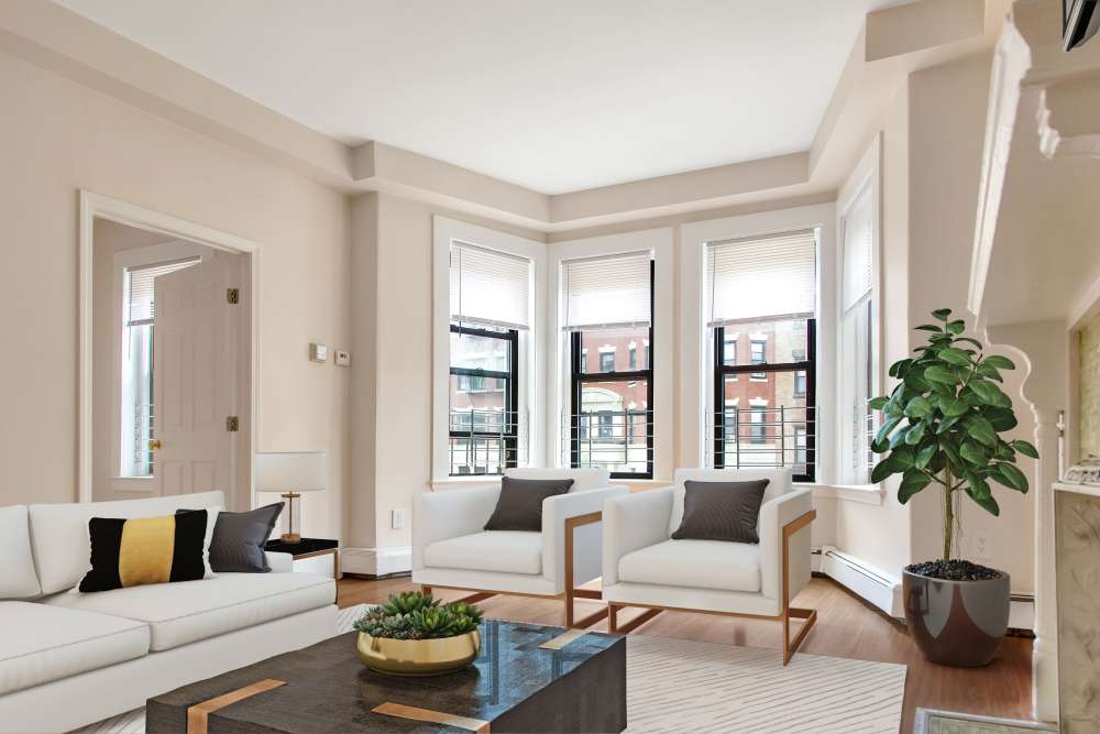 Elegant living room with sectional sofa, armchairs, coffee table, and large windows at 71 Westland Apartments in Boston, Massachusetts