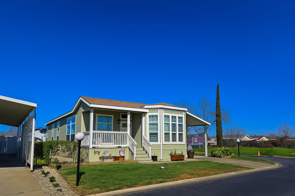 Gray manufactured home with attached garage at Dell-Wayne Estates in Yuba City, California