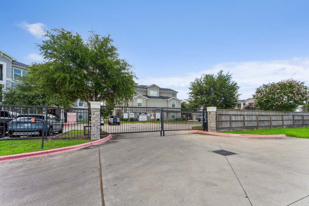 The gated drive-through entry at the front at Aria Victoria Apartments in Victoria, Texas