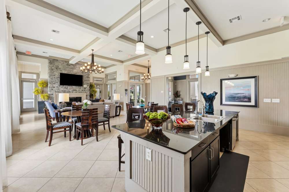 View of resident dining space from the prep kitchen in the clubhouse at Aria Victoria Apartments in Victoria, Texas
