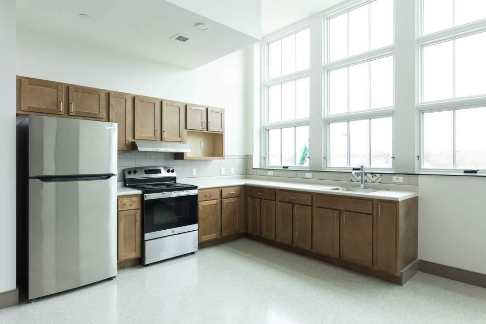 Bright kitchen with stainless steel appliances at Elias Brookings Apartments in Springfield, Massachusetts