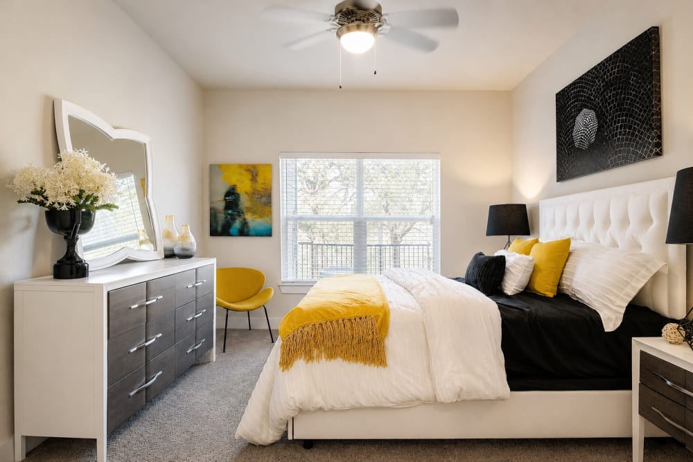 Cozy bedroom with a bright window at Esperanza in San Antonio, Texas