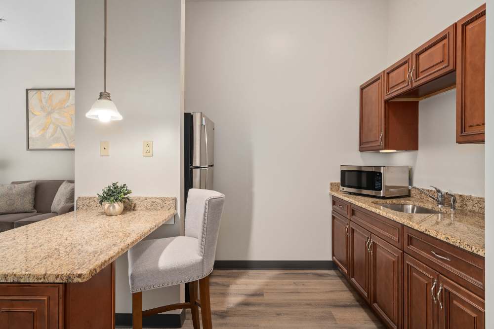 Senior living apartment with kitchenette and dining area at Gentry Park Orlando in Orlando, Florida
