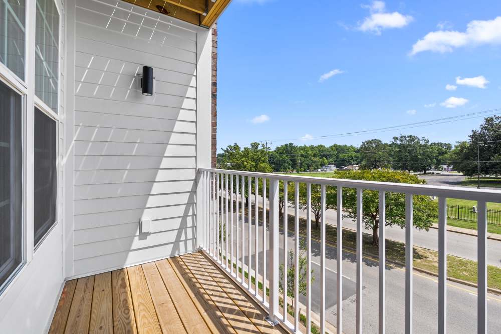Private apartment balcony overlooking landscaped community grounds at The Cascade at Foundry Creek in Richmond, Virginia