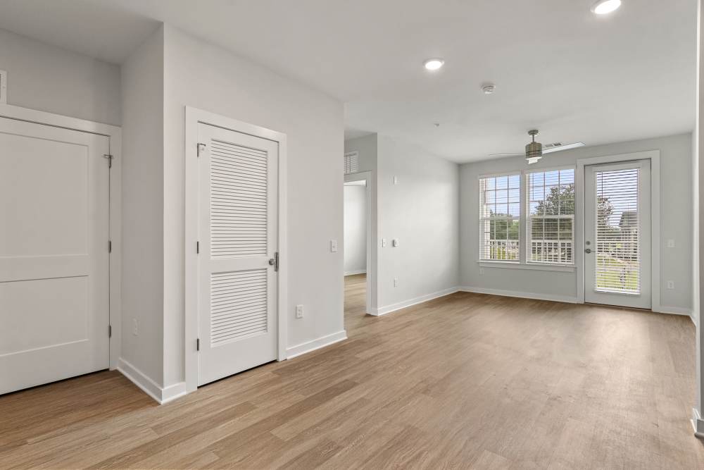Bedroom with double closets and adjacent living area at The Cascade at Foundry Creek in Richmond, Virginia