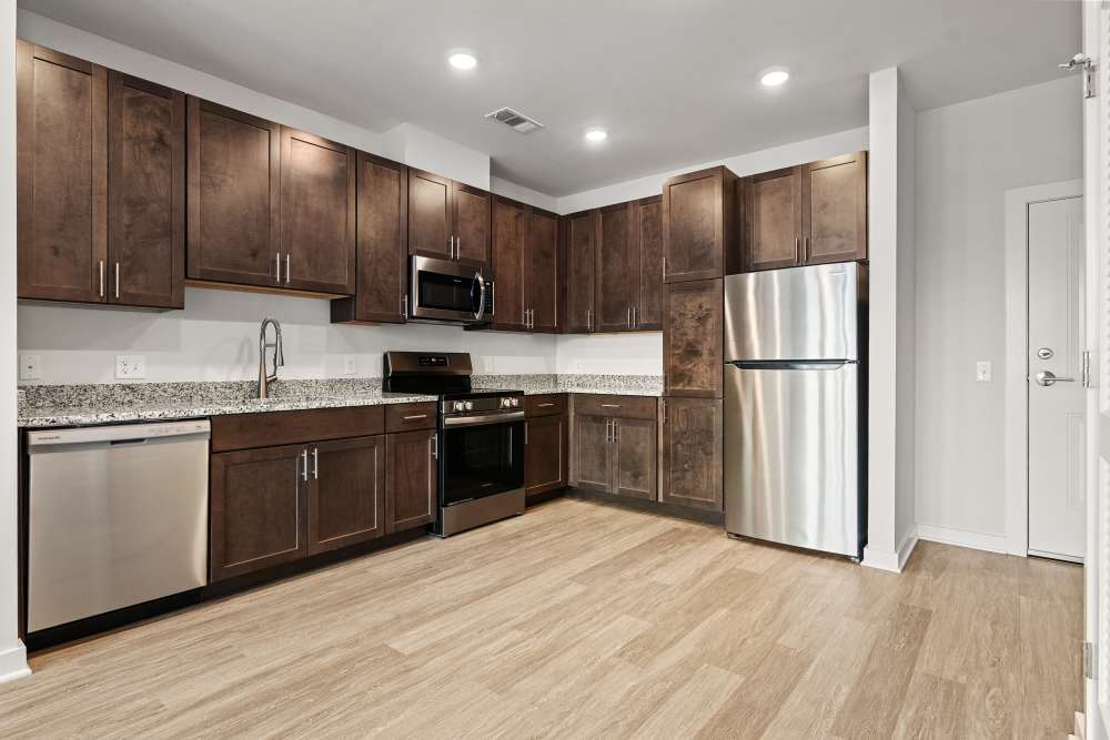 Contemporary kitchen with stainless steel appliances and dark cabinetry at The Cascade at Foundry Creek in Richmond, Virginia