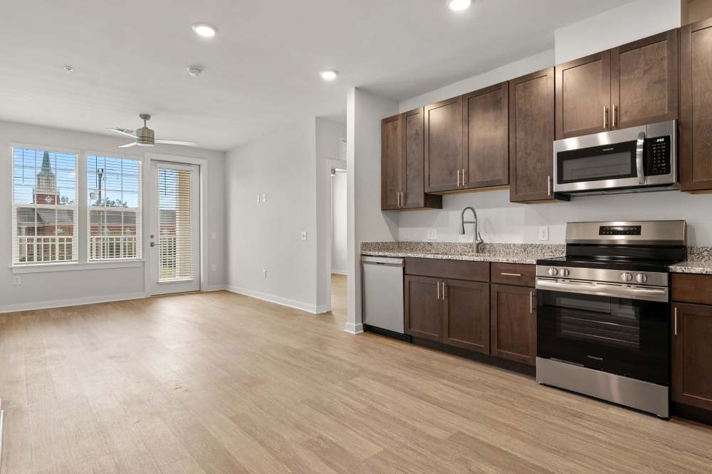 Open living room and kitchen with modern cabinetry at The Cascade at Foundry Creek in Richmond, Virginia