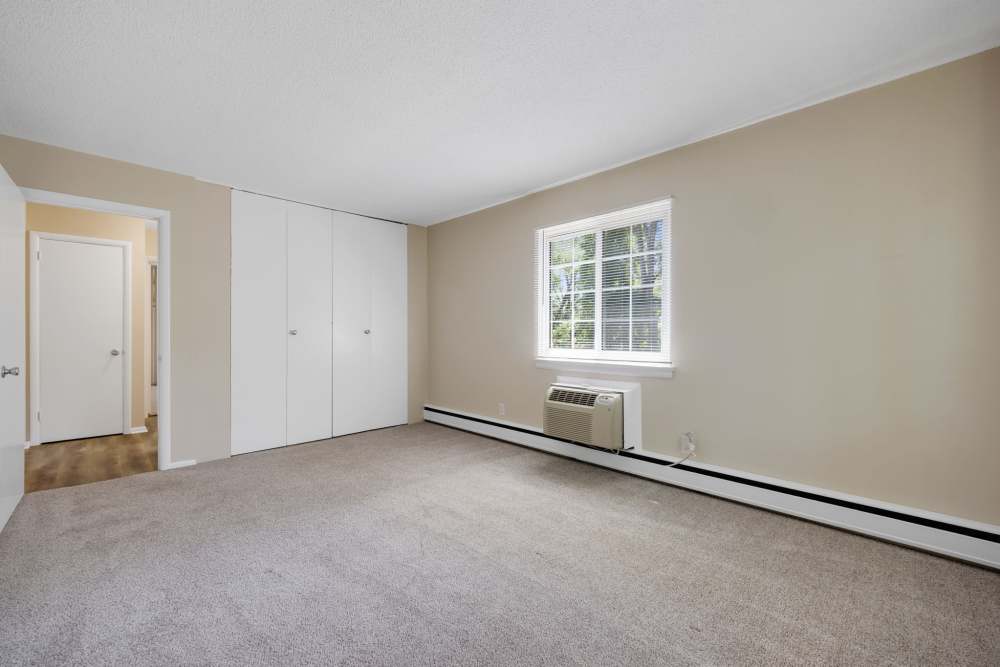 Spacious bedroom with carpet flooring and natural light at Pittsford Village Estates in Pittsford, New York