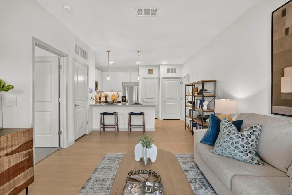 Living room looking into kitchen in apartment at Fidelis Willis.