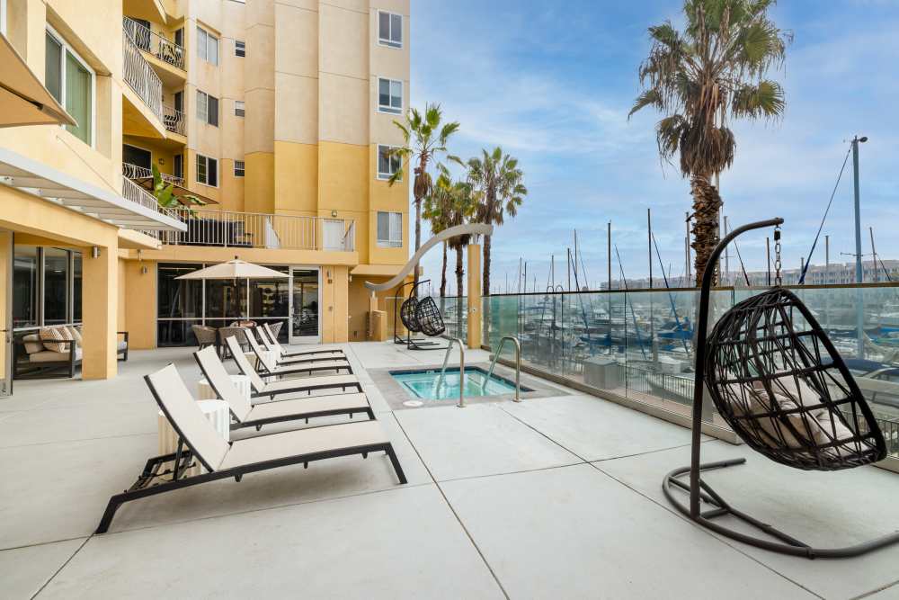 Resort-style pool area with lounge chairs at St Tropez Apartments in Marina Del Rey, California