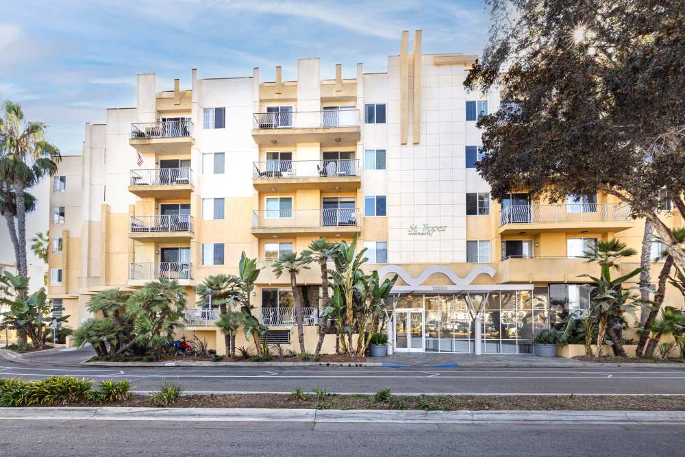 Bright exterior with tropical landscaping at St Tropez Apartments in Marina Del Rey, California