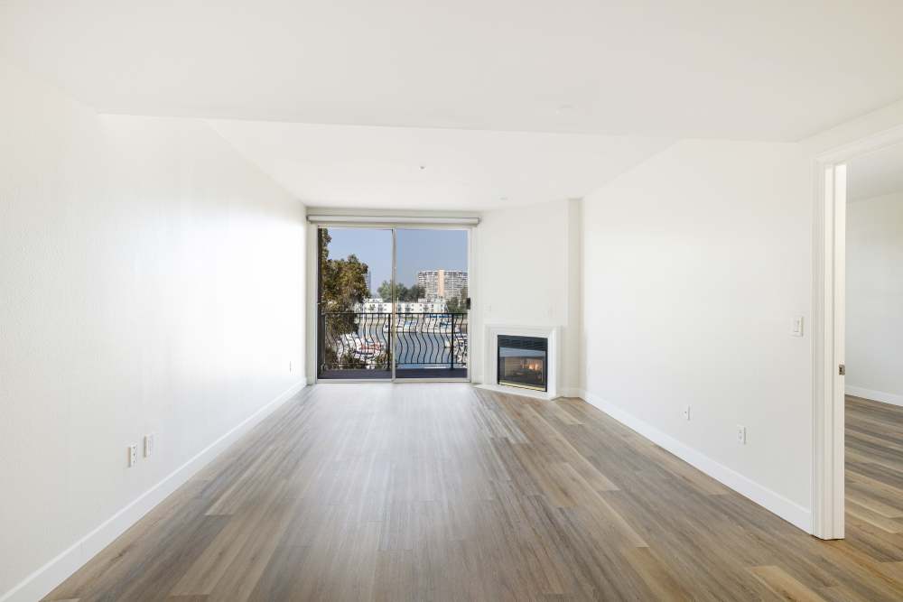 Spacious living room with balcony view at St Tropez Apartments in Marina Del Rey, California