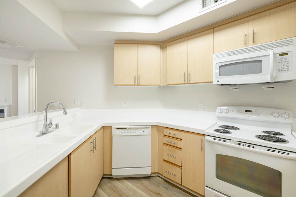 Bright open kitchen with modern appliances at St Tropez Apartments in Marina Del Rey, California