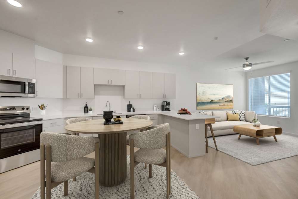 Open kitchen with dining area and connected living space at Heirloom at Bruner in Las Vegas, Nevada