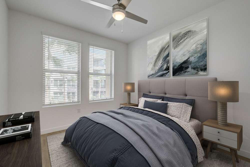Cozy bedroom with upholstered bed, matching lamps, and window light at Heirloom at Bruner in Las Vegas, Nevada