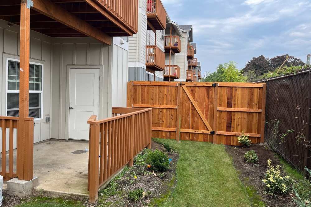 Private fenced apartment patio with lawn and covered entryway, Cleveland Crossings in Woodburn, Oregon