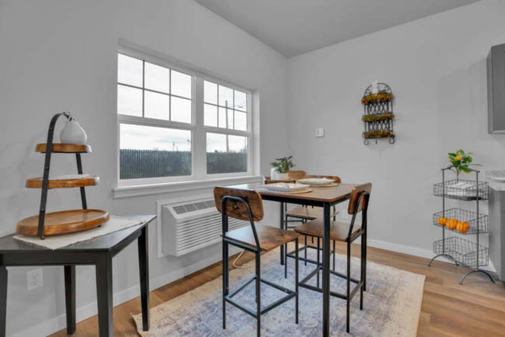 Dining nook with large window, breakfast table, and outdoor views, at Cleveland Crossings in Woodburn, Oregon