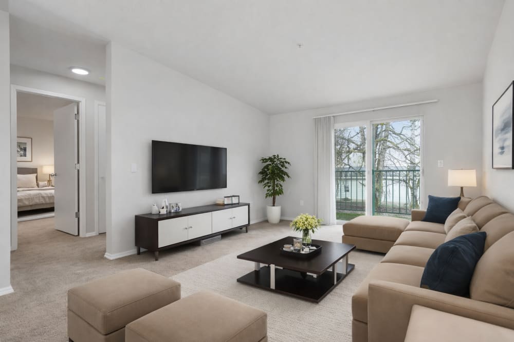Open-concept living room with contemporary seating, large windows, and modern finishes at Reedville Meadows in Beaverton, Oregon  