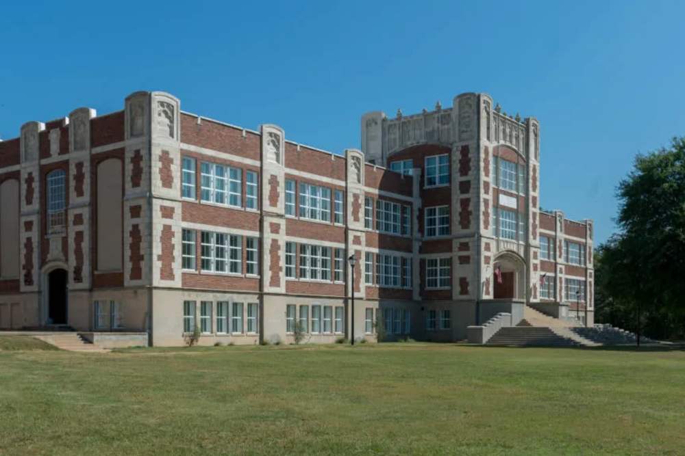 Historic brick school building exterior with steps near A.L. Miller Village in Macon, Georgia