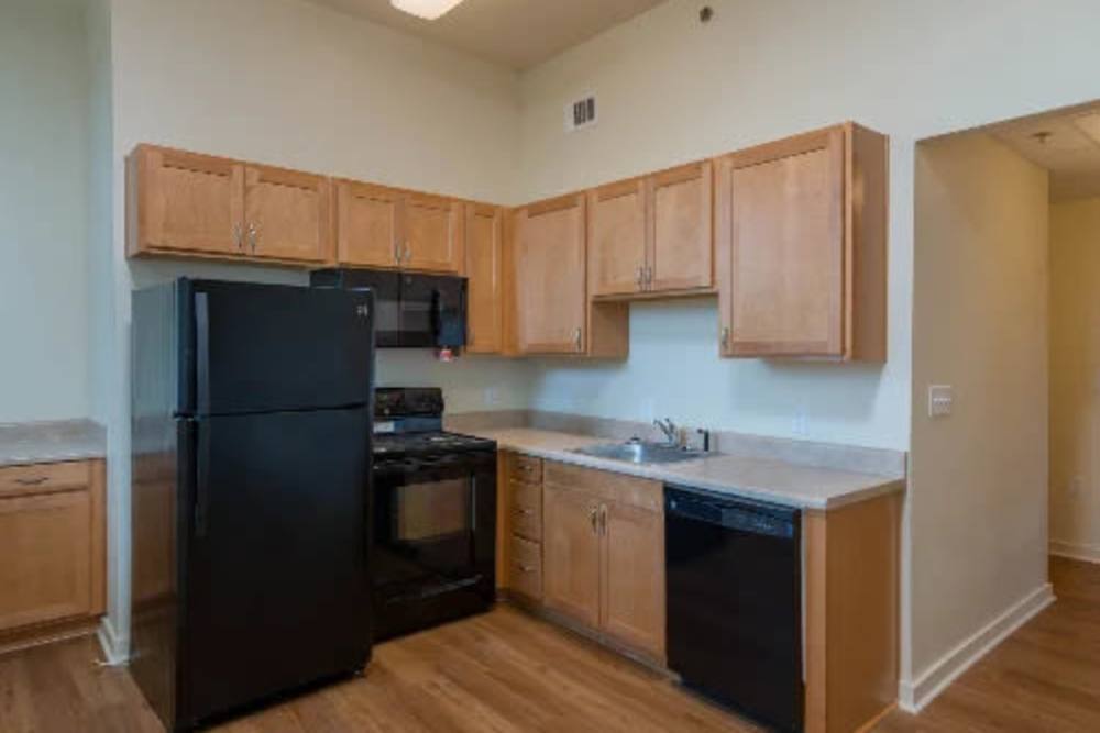 Modern kitchen with wood cabinetry at A.L. Miller Village in Macon, Georgia