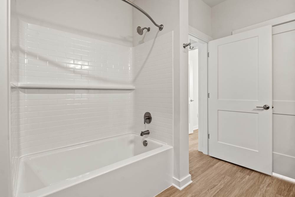 Bathroom with bathtub, shower, and bright white finishes at The Cascade at Foundry Creek in Richmond, Virginia