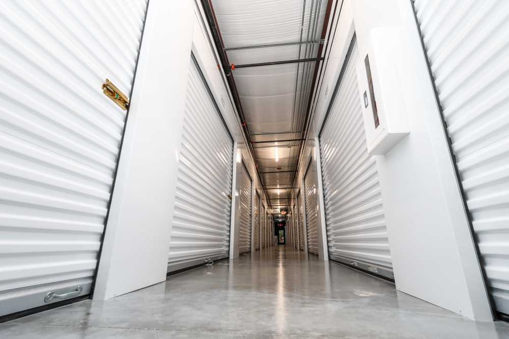 Brightly lit storage unit hallway at Your Storage Units Bunnell in Bunnell, Florida
